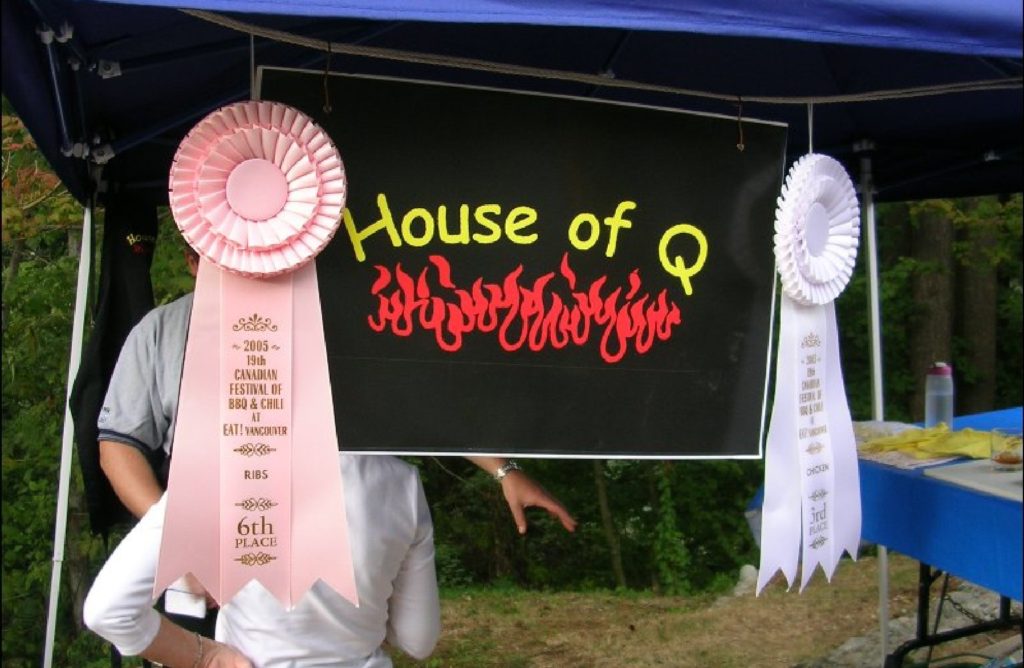 HoQ Awards beside printed banner 2005