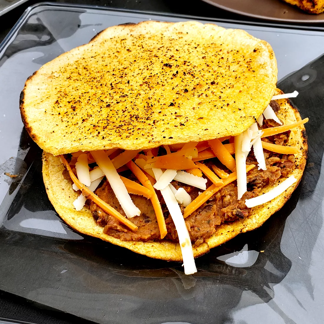 Tostada base with BBQ Refried Beans