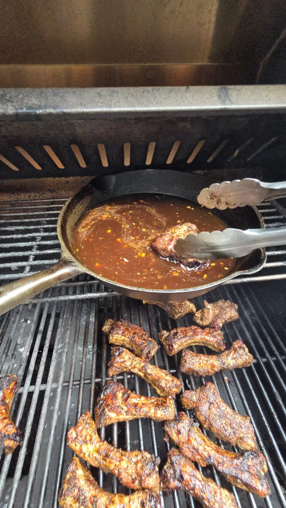 placing ribs into sauce vertical