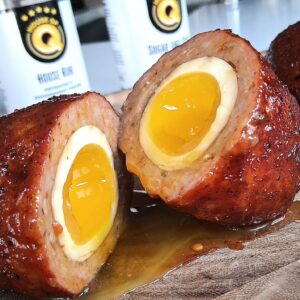 slow smoked scotch eggs split open with creamy egg yolk